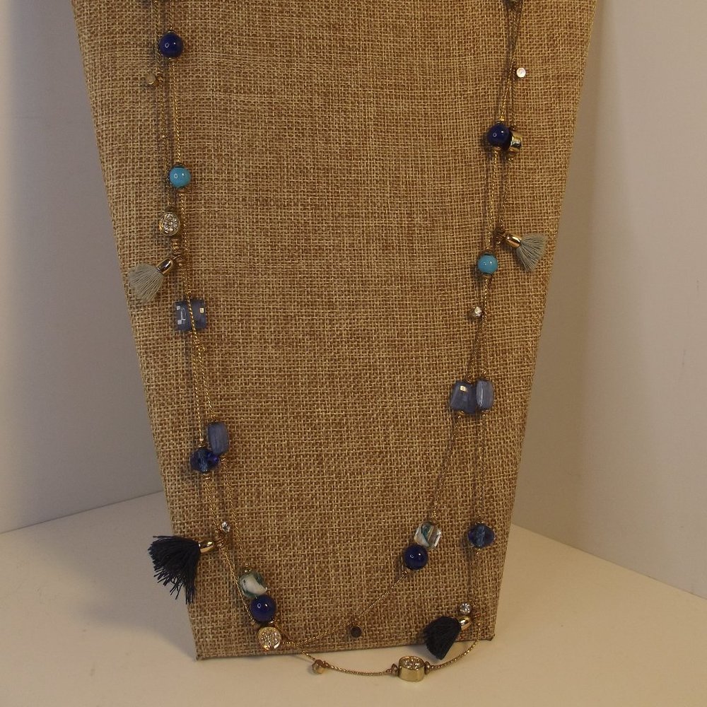 Long strand of Gold Tone Chain with stations of Blue Tassel, Glass Beads & More